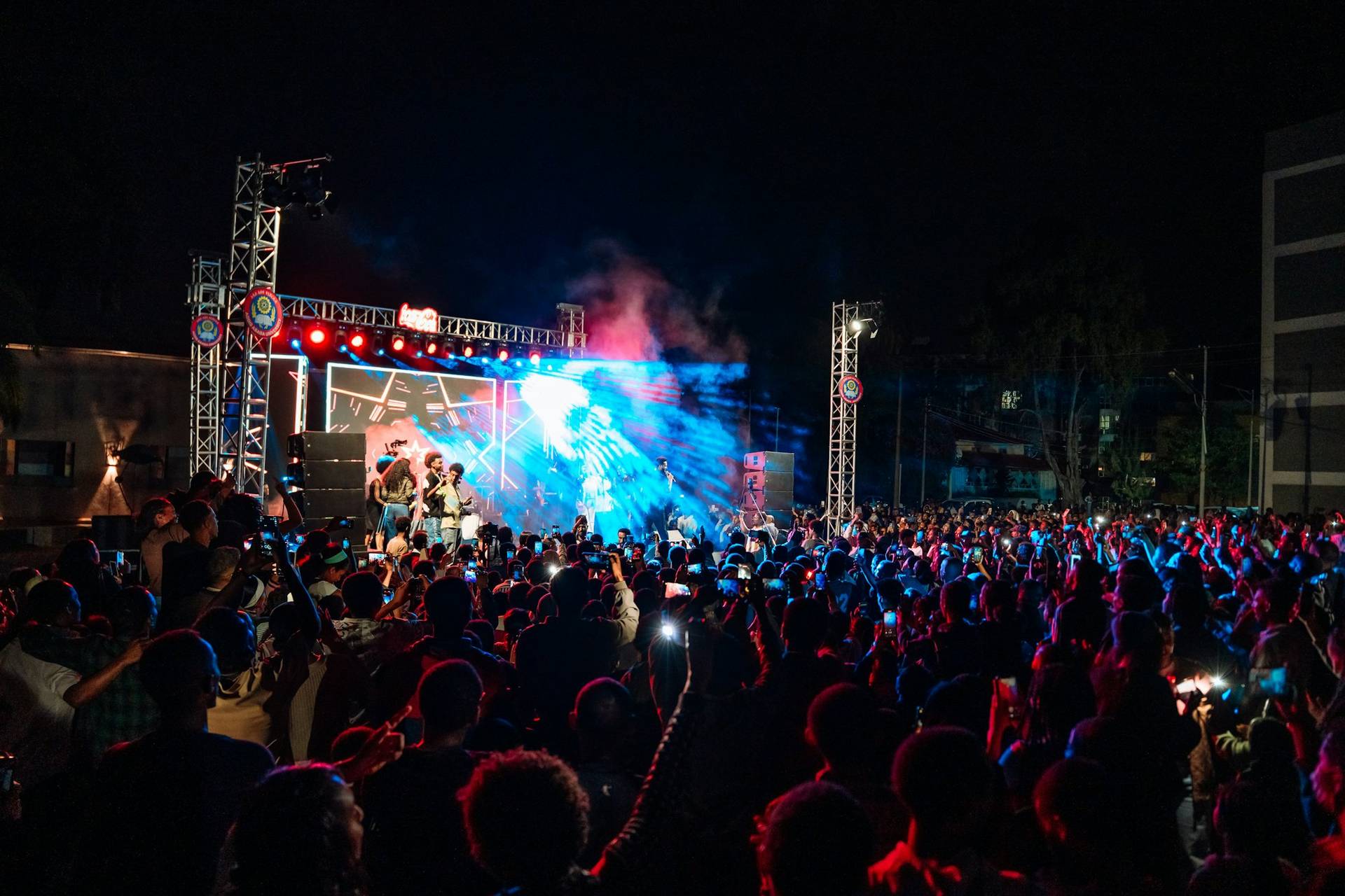 A crowd at an outdoor concert at night