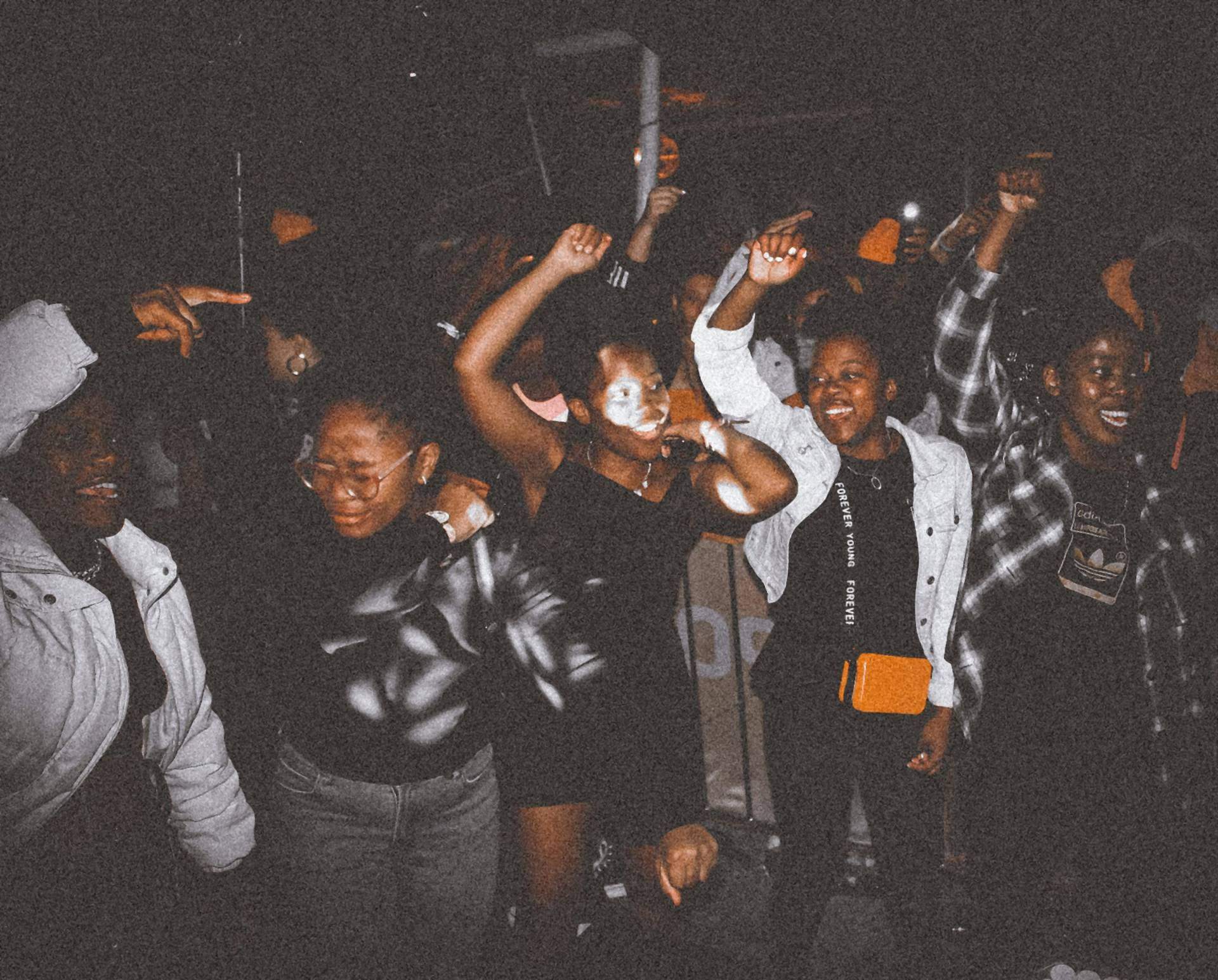 Friends dancing at a packed party